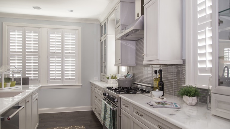 Plantation shutters in Raleigh kitchen with modern appliances.